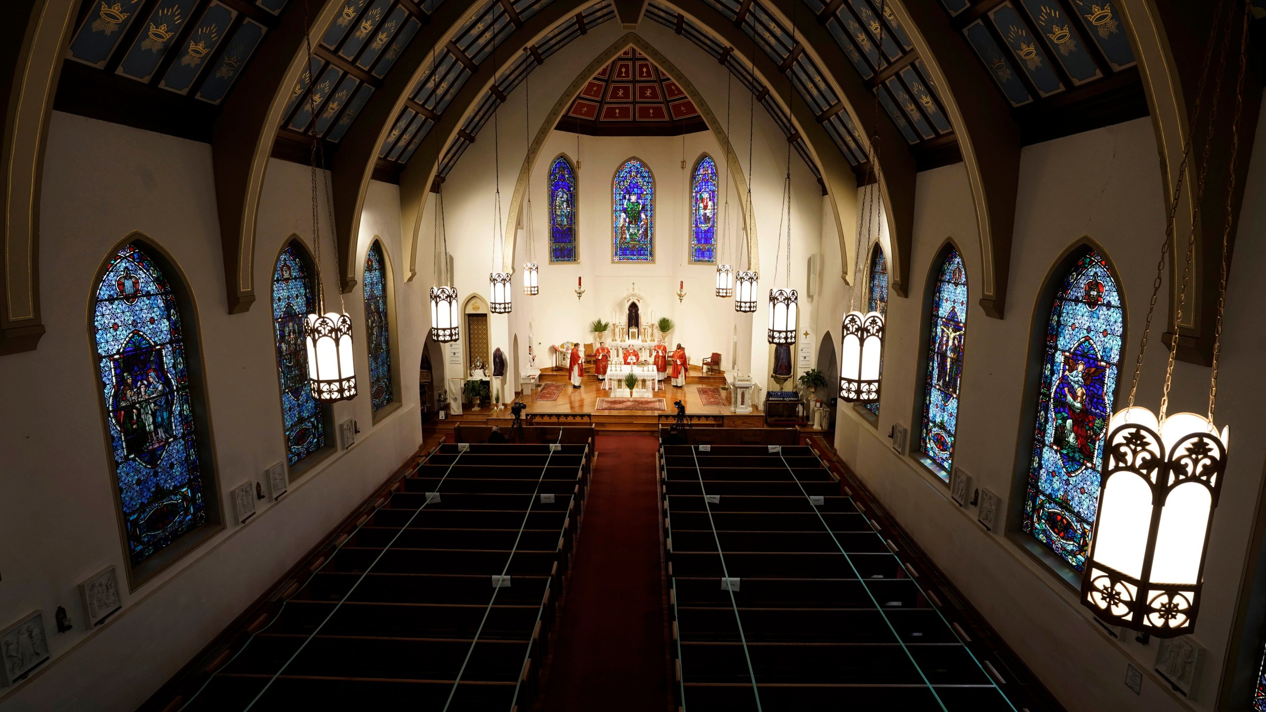 In this April 5, 2020, file photo, The Most Rev. Peter Jugis, Bishop of Charlotte, conducts Palm Sunday services inside the empty St. Patrick Cathedral in Charlotte, N.C. (David T. Foster III/The Charlotte Observer via AP)