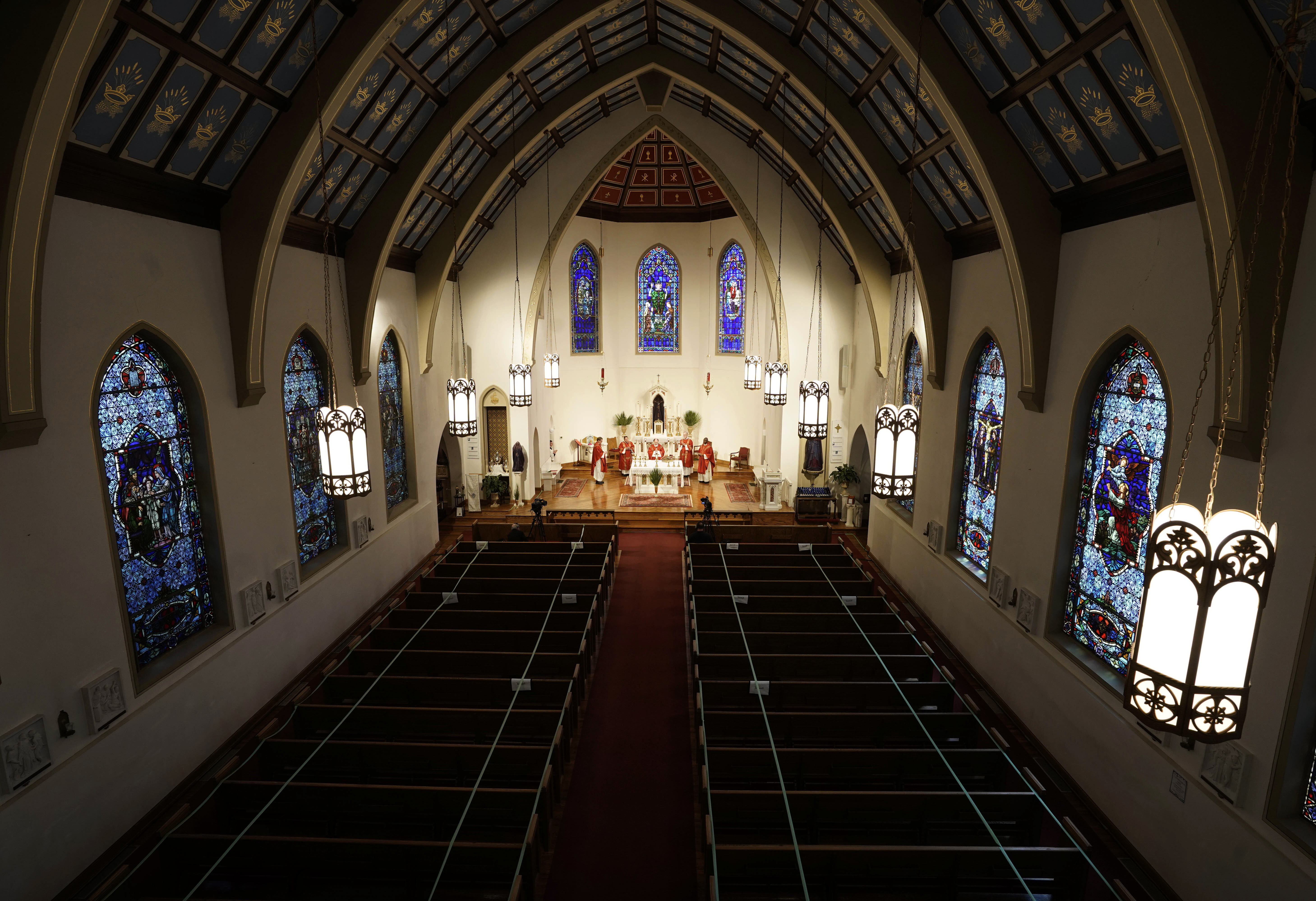 In this April 5, 2020, file photo, The Most Rev. Peter Jugis, Bishop of Charlotte, conducts Palm Sunday services inside the empty St. Patrick Cathedral in Charlotte, N.C. (David T. Foster III/The Charlotte Observer via AP)