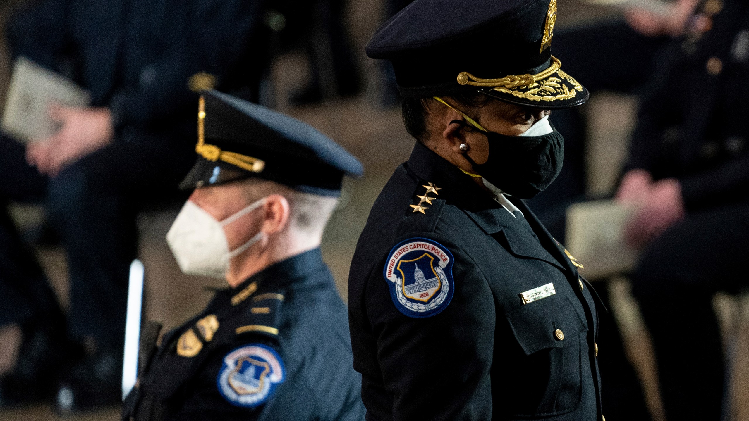 Capitol Police Acting Chief Yogananda Pittman departs a ceremony memorializing U.S. Capitol Police officer Brian Sicknick, as an urn with his cremated remains lies in honor on a black-draped table at the center of the Capitol Rotunda on Feb. 3, 2021. (Erin Schaff/The New York Times via AP, Pool)