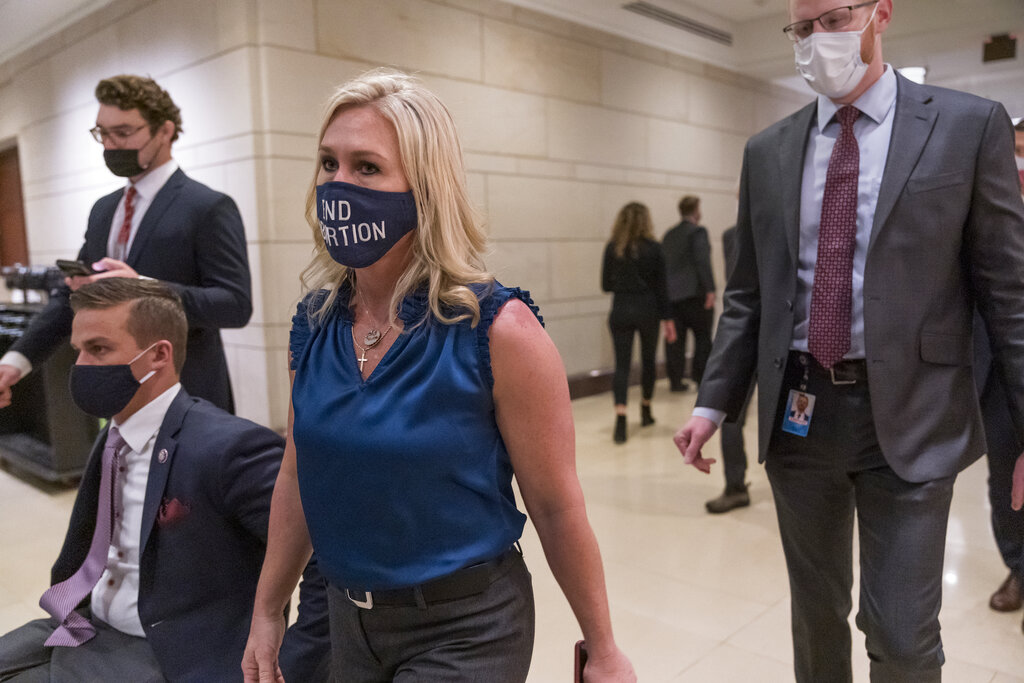 Rep. Marjorie Taylor Greene, R-Ga., walks with fellow House Republicans on Capitol Hill in Washington, Wednesday, Feb. 3, 2021, following a meeting called by House Minority Leader Kevin McCarthy. (AP Photo/J. Scott Applewhite)