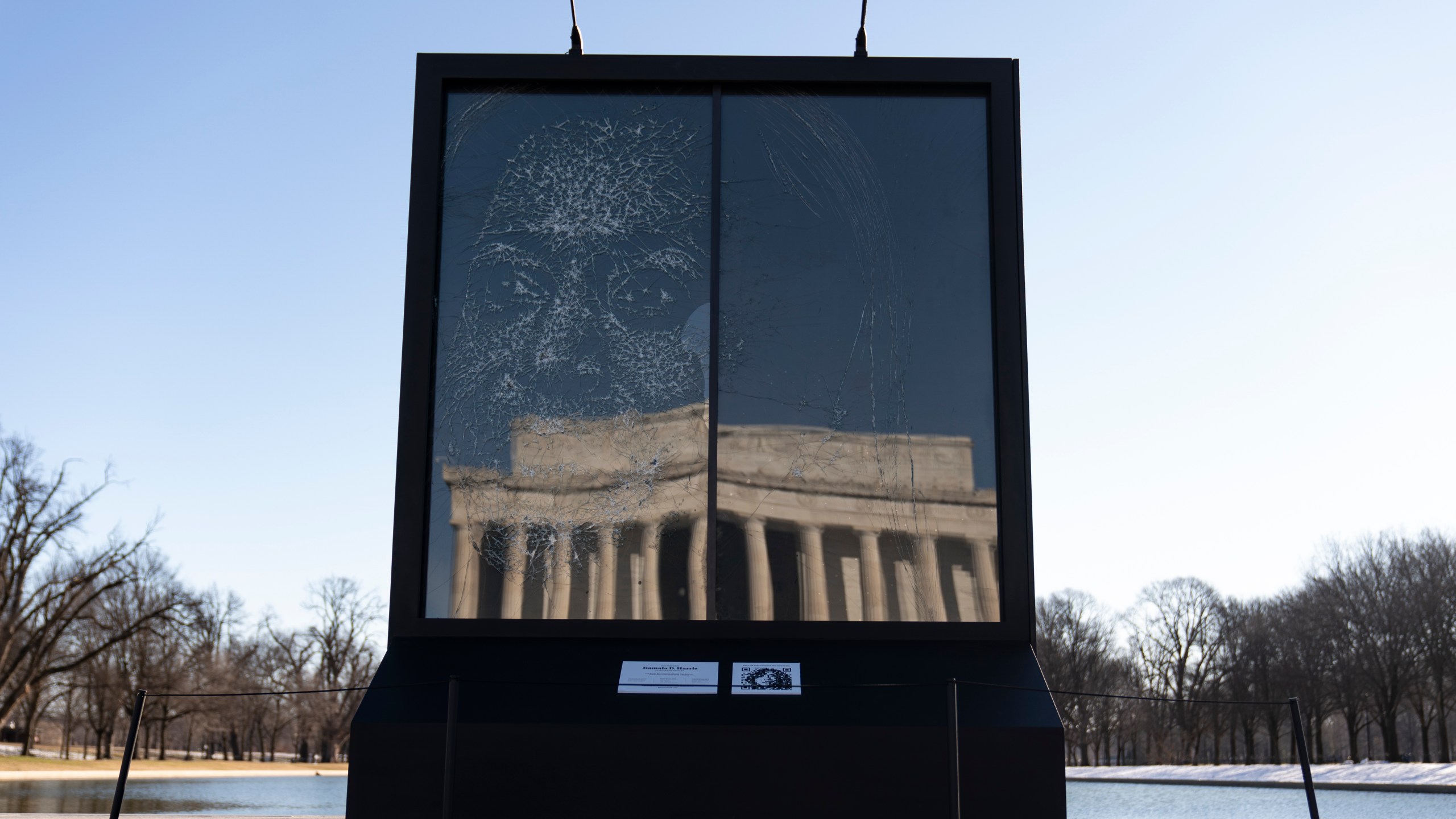 The installation "Vice President Kamala Harris Glass Ceiling Breaker" is seen at the Lincoln Memorial, reflected, in Washington, Wednesday, Feb. 4, 2021. Vice President Kamala Harris' barrier-breaking career has been memorialized in a portrait depicting her face emerging from the cracks in a massive sheet of glass. Using a photo of Harris that taken by photographer Celeste Sloman, artist Simon Berger lightly hammered on the slab of laminated glass to create the portrait of Harris. (AP Photo/Carolyn Kaster)