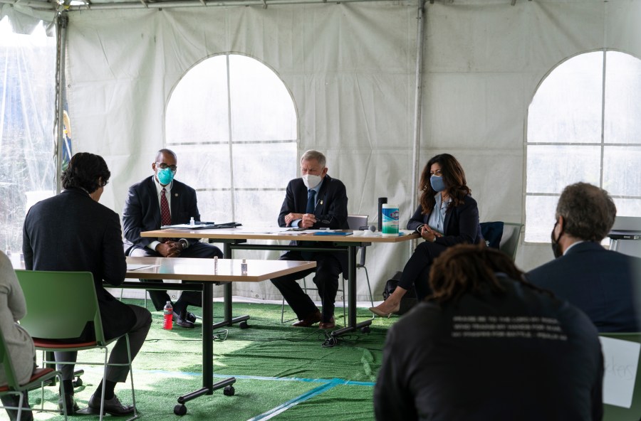 Los Angeles City Council member Kevin de Leon, far left, addresses U.S. District Judge Andre Birotte, second from left, U.S. District Court Judge David Carter, middle, and special master Michele Martinez, right, at a court hearing inside a tent at Downtown Women's Center in Los Angeles on Feb. 4, 2021. (AP Photo/Damian Dovarganes)