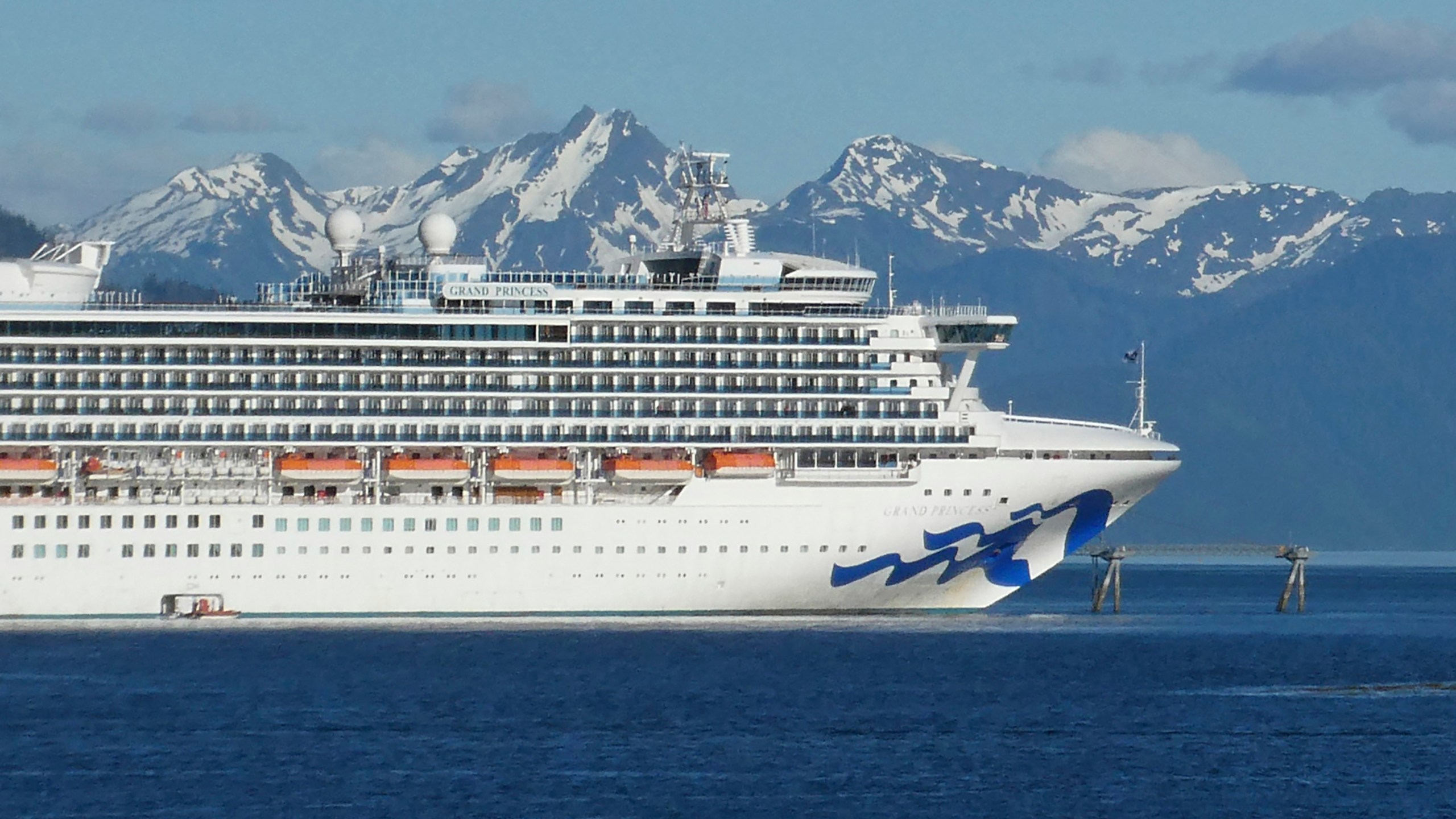 In this May 30, 2018, file photo, is the Grand Princess cruise ship in Gastineau Channel in Juneau, Alaska. The Canadian government has extended a ban on cruise ships through February 2022, which is expected to block trips from visiting Alaska this year. Transport Canada announced the extension of the ban put in place because of the COVID-19 pandemic. (AP Photo/Becky Bohrer, File)