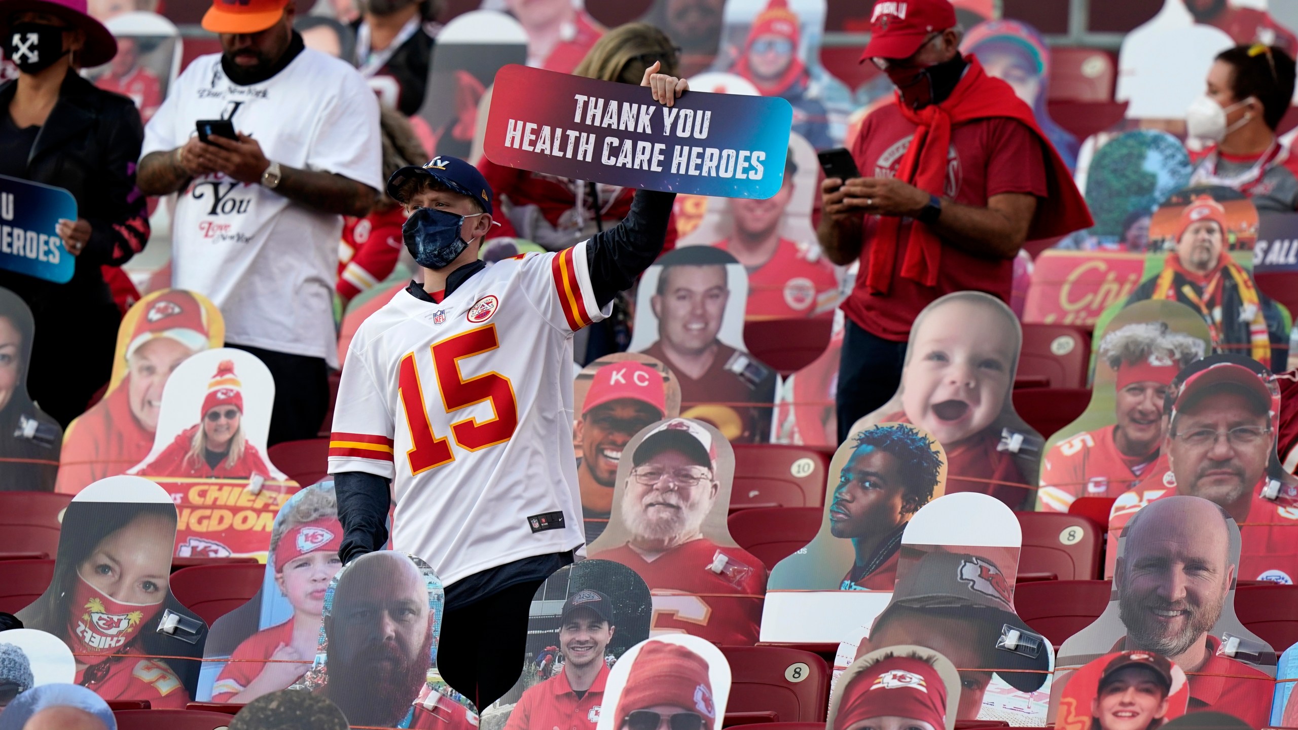 A fan holds up a sign honoring heart care workers before the NFL Super Bowl 55 football game between the Kansas City Chiefs and Tampa Bay Buccaneers, Sunday, Feb. 7, 2021, in Tampa, Fla. (AP Photo/Lynne Sladky)