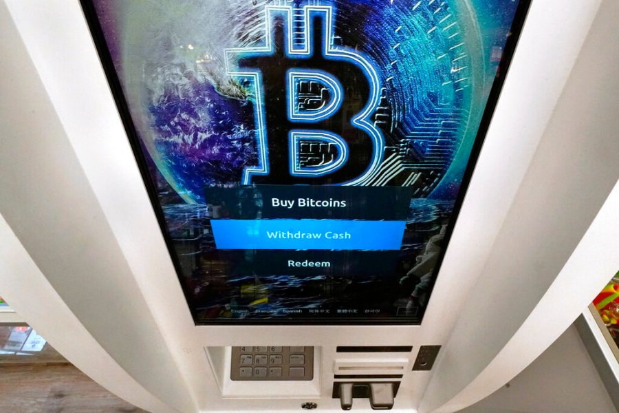 The Bitcoin logo appears on the display screen of a crypto currency ATM at the Smoker's Choice store, Tuesday, Feb. 9, 2021, in Salem, N.H. (AP Photo/Charles Krupa)