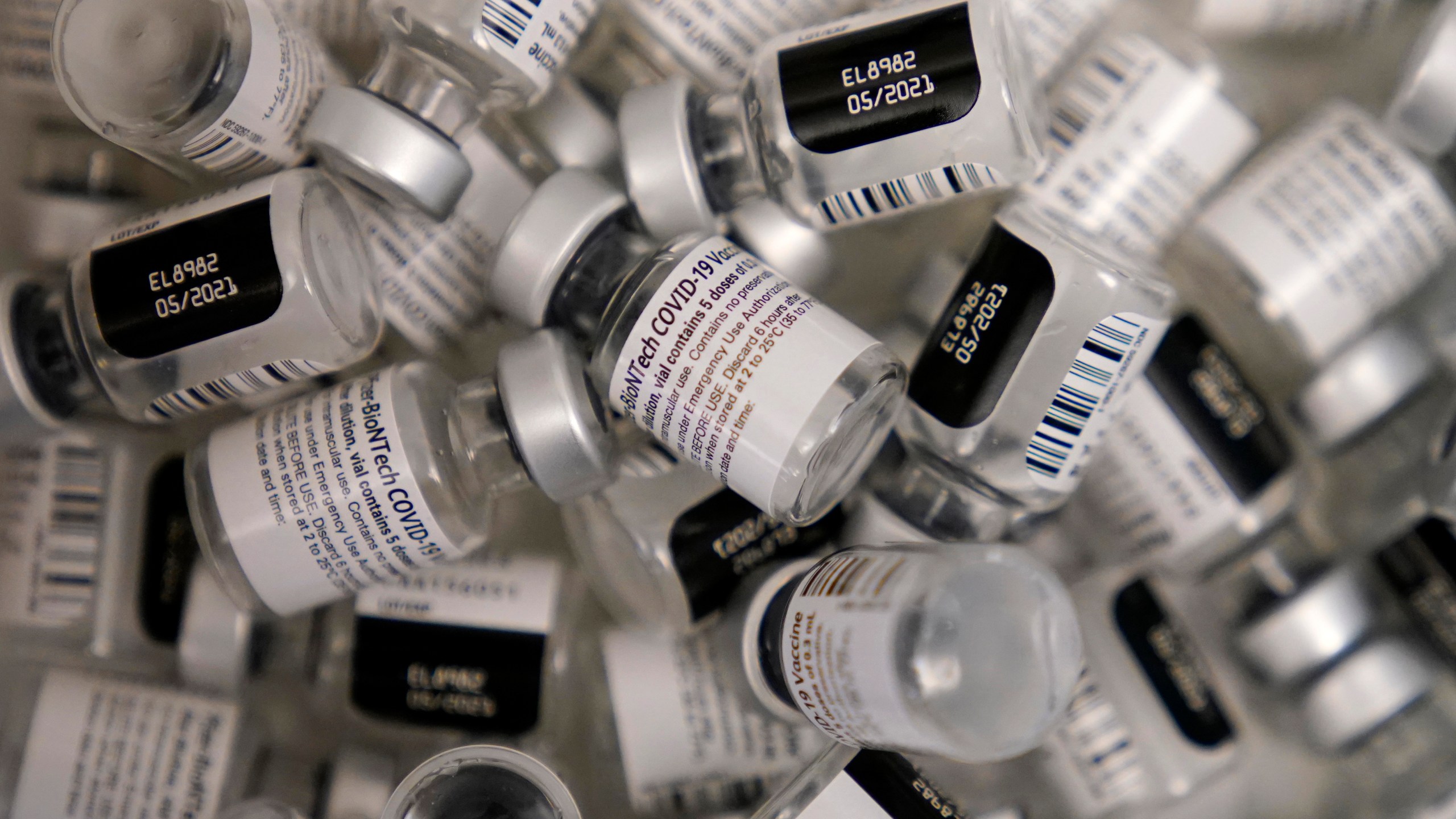 In this Jan. 22, 2021, file photo, empty vials of the Pfizer-BioNTech COVID-19 vaccine are seen at a vaccination center at the University of Nevada, Las Vegas, in Las Vegas. (AP Photo/John Locher, File)