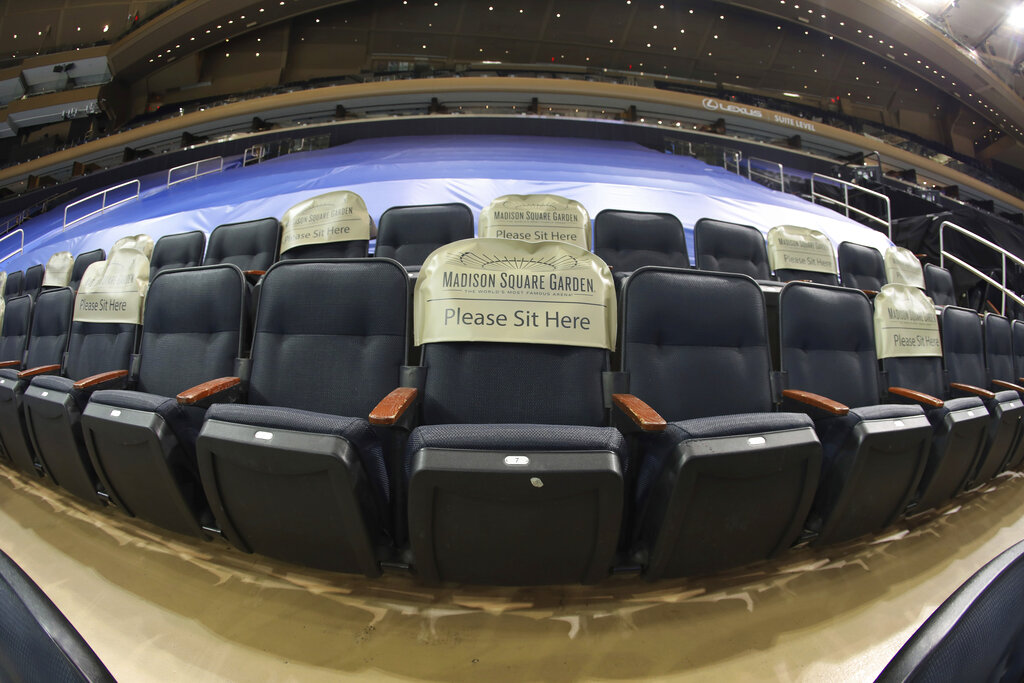 Seats are earmarked for fans at future games prior to the NHL hockey game between the New York Rangers and the Boston Bruins at Madison Square Garden Wednesday, Feb. 10, 2021, in New York. (Bruce Bennett/Pool Photo via AP)