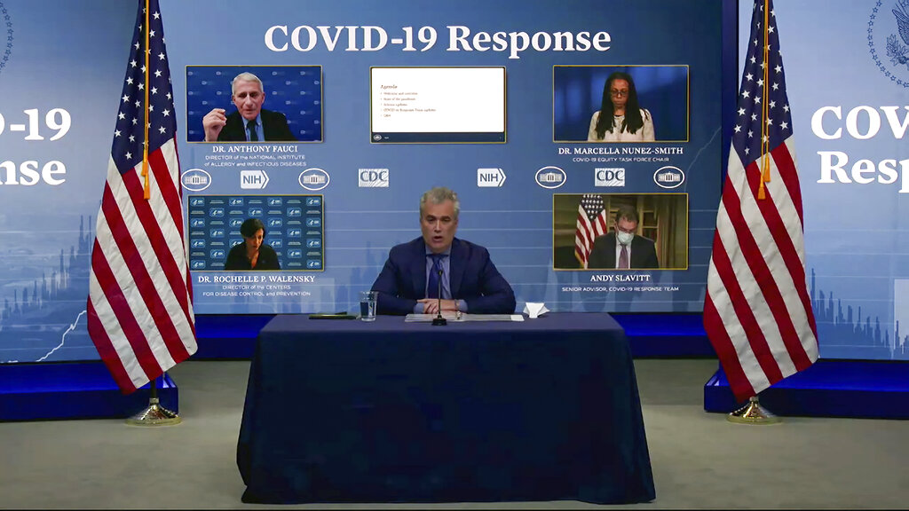 In this Jan. 27, 2021, image from video, White House coronavirus response coordinator Jeff Zients (center) speaks during a White House briefing on the Biden administration's response to the COVID-19 pandemic in Washington. (White House via AP)