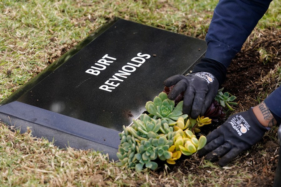 Flowers are placed in front of a temporary headstone for the late actor Burt Reynolds in the Garden of Legends section of Hollywood Forever cemetery, on Feb. 11, 2021. (Chris Pizzello/Associated Press)