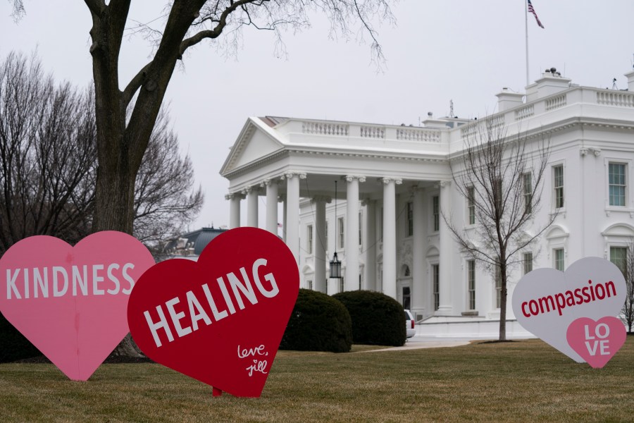 A Valentine's Day decoration, signed by first lady Jill Biden, sits on the North Lawn of the White House, Friday, Feb. 12, 2021, in Washington. (AP Photo/Evan Vucci)