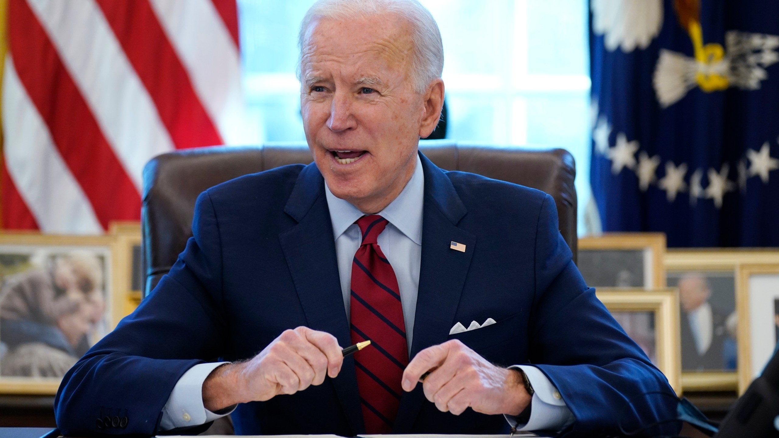 In this Jan. 28, 2021 file photo, President Joe Biden signs a series of executive orders in the Oval Office of the White House in Washington. (AP Photo/Evan Vucci)