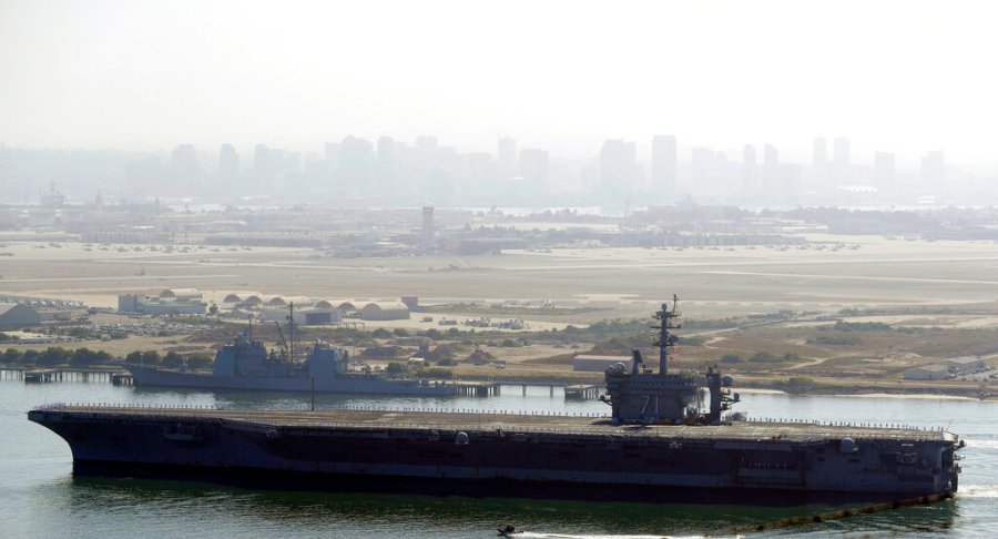 In this July 9, 2020 file photo the USS Theodore Roosevelt aircraft carrier makes its way into San Diego Bay as seen from San Diego. AP Photo/Gregory Bull, File)