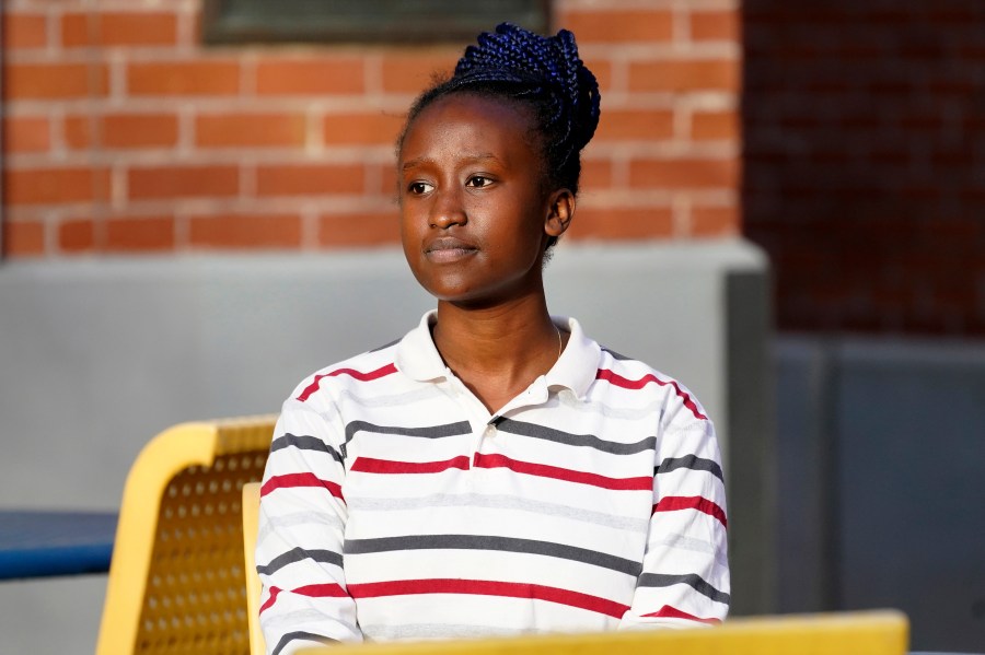 Peniella Irakoze sits on campus during a break from her part-time job at Phoenix College Thursday, Jan. 28, 2021 in Phoenix. Irakoze is working through a list of more than 1,000 fellow students who didn’t return to Phoenix College this semester, calling to check how they’re doing during the coronavirus pandemic. The National Student Clearinghouse says enrollment at U.S. community colleges dropped 10% from fall 2019 to fall 2020 amid the pandemic. (AP Photo/Matt York)