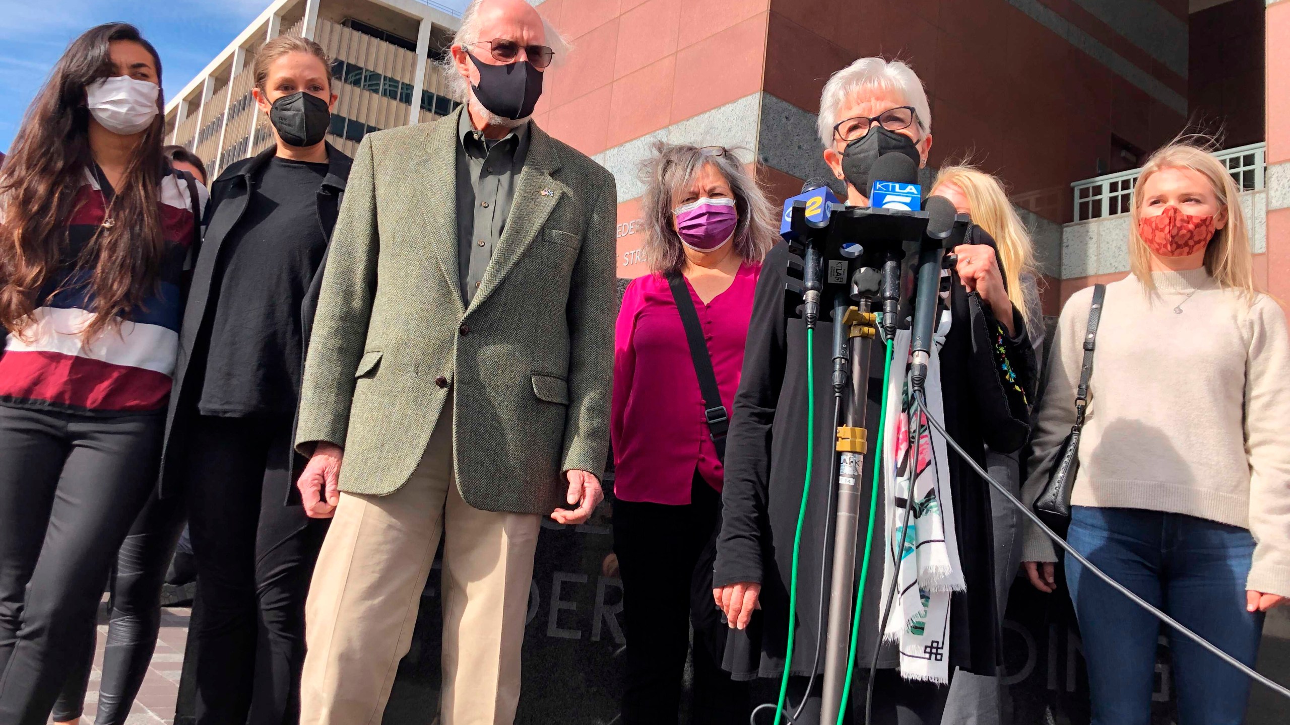 Kathleen McIlvain, center, speaks outside federal court in Los Angeles on Feb. 16, 2021, after the court appearance of Jerry Boylan, a scuba dive boat captain who is charged with 34 counts of seaman's manslaughter. McIlvain's son, Charles McIlvain, was among 34 people killed during a 2019 fire aboard Boylan's boat. (Stefanie Dazio / Associated Press)