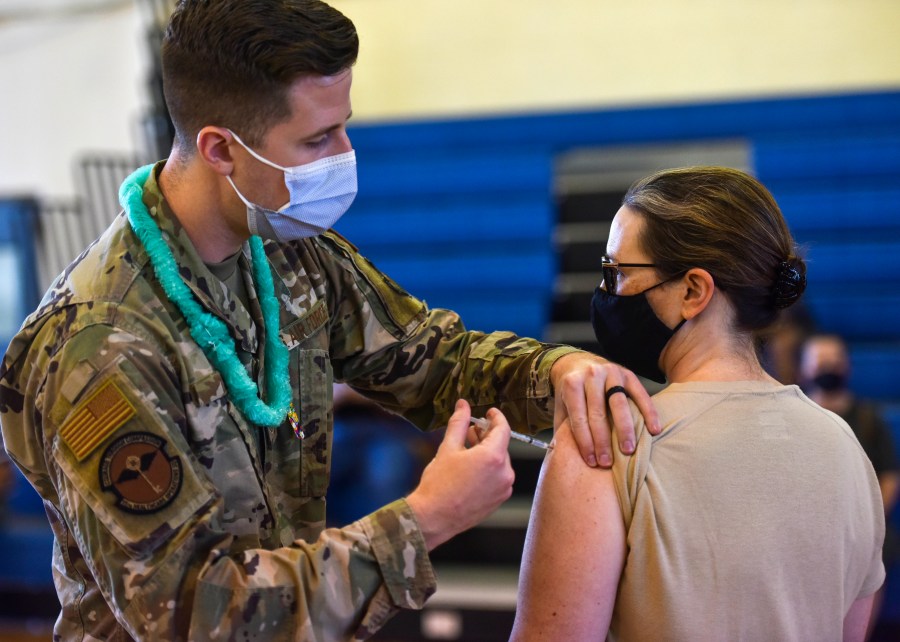 In this Feb. 9, 2021 photo provided by the Department of Defense, Hickam 15th Medical Group host the first COVID-19 mass vaccination on Joint Base Pearl Harbor-Hickam. By the thousands, U.S. service members are refusing or putting off the COVID-19 vaccine, as frustrated commanders scramble to knock down internet rumors and find the right pitch that will convince troops to take the shot. Some Army units are seeing as few as a third agree to the vaccine, others are higher. (U.S. Air Force Tech. Sgt. Anthony Nelson Jr./Department of Defense via AP)