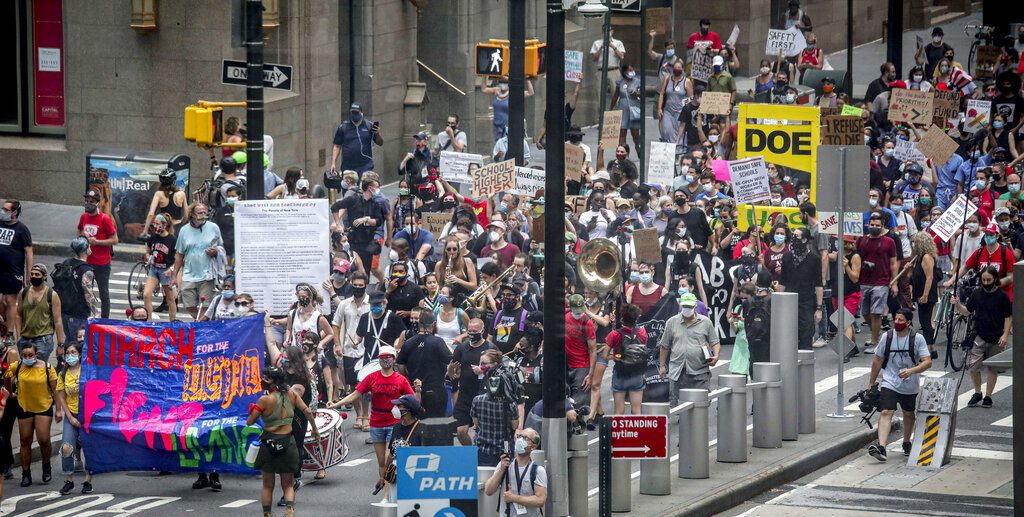 In this Aug. 3, 2020, file photo, a coalition of teachers, students, and families protest during a rally called National Day of Resistance Against Unsafe School Reopening Opening, in New York. President Joe Biden is pushing for K-8 schools to fully reopen in his first 100 days. (AP Photo/Bebeto Matthews, File)