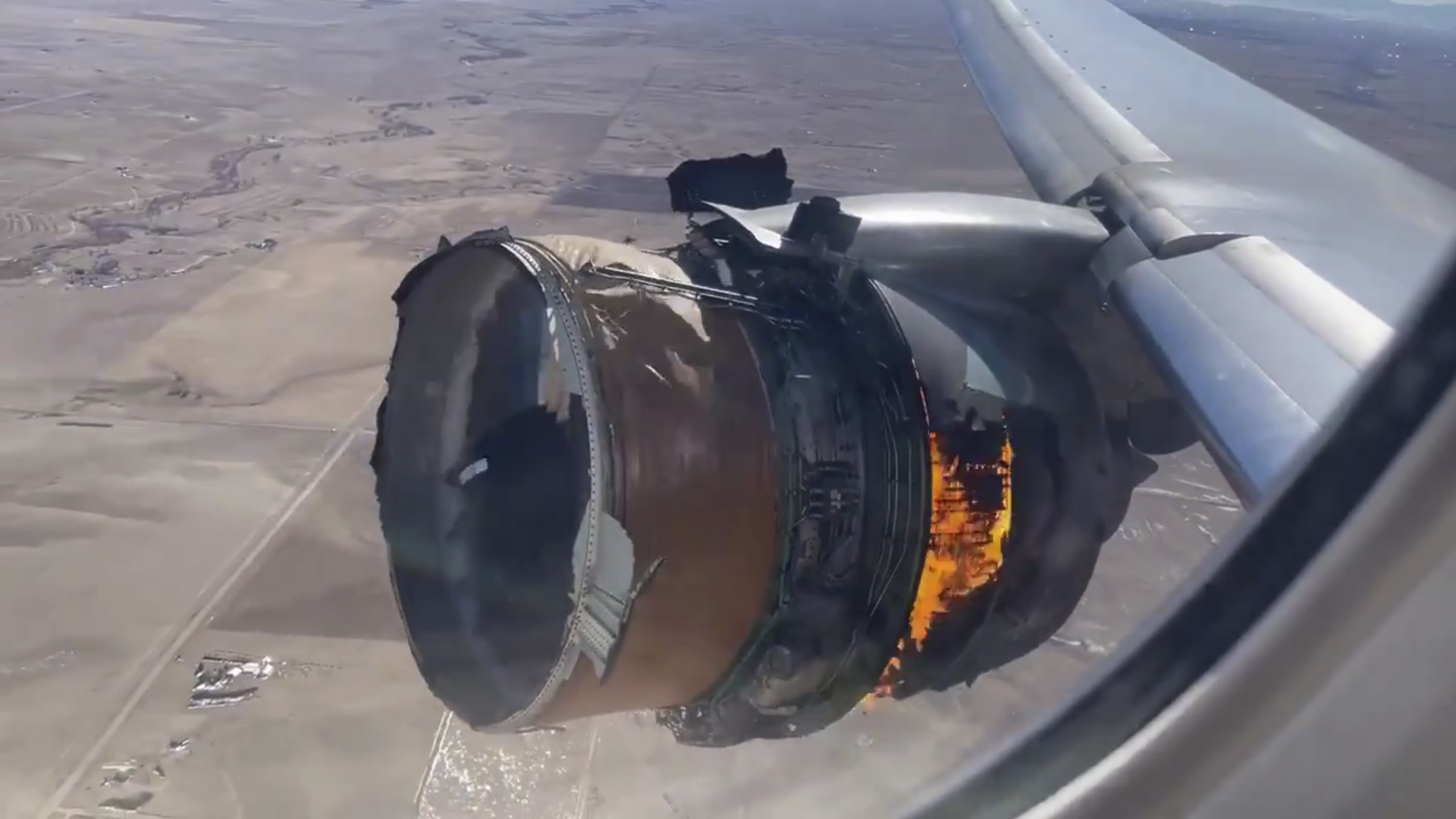 In this image taken from video, the engine of United Airlines Flight 328 is on fire after after experiencing "a right-engine failure" shortly after takeoff from Denver International Airport on Feb. 20, 2021. (Chad Schnell via Associated Press)