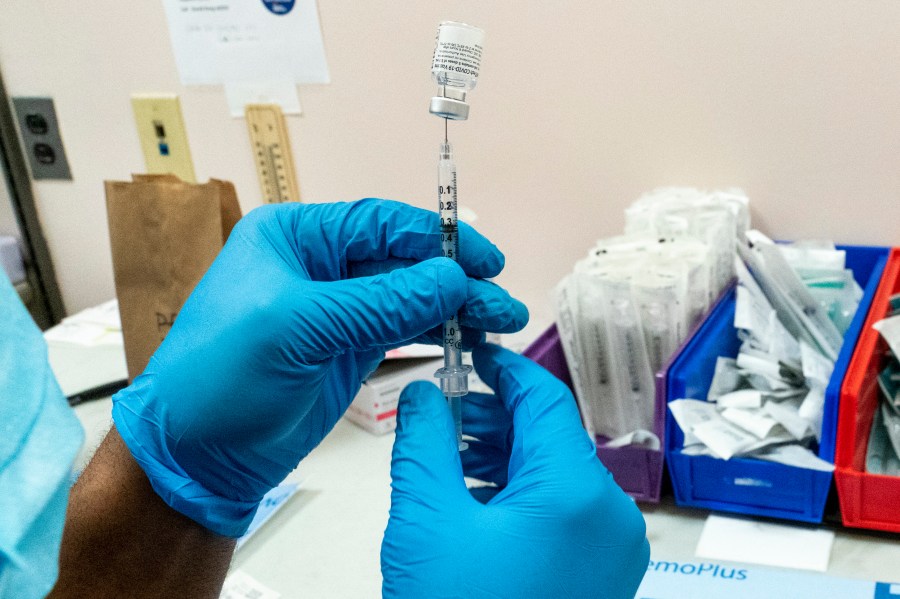 In this Thursday, Feb. 18, 2021 file photo, a pharmacist prepares a syringe with Pfizer’s vaccine at a COVID-19 vaccination site in New York. (Mary Altaffer/Associated Press)