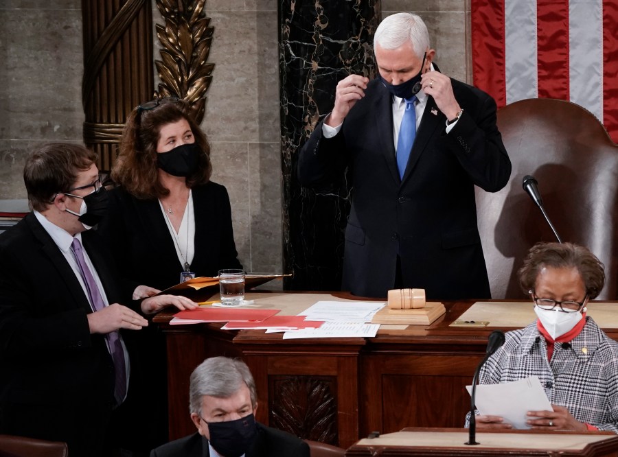 In this Jan. 6, 2021, photo, Senate Parliamentarian Elizabeth MacDonough, left, works beside Vice President Mike Pence during the certification of Electoral College ballots in the presidential election, in the House chamber at the Capitol in Washington. (AP Photo/J. Scott Applewhite)