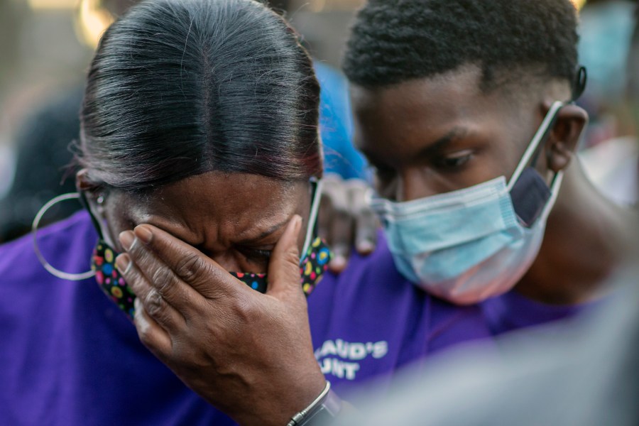 Evon Arbery, Ahmaud Arbery's aunt, left, is comforted by family during a memorial walk and candlelight vigil for her nephew in Brunswick, Ga., on Feb. 23, 2021. (Stephen B. Morton / Associated Press)