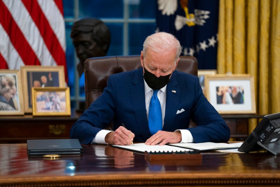 In this Feb. 2, 2021, file photo, President Joe Biden signs an executive order, in the Oval Office of the White House, in Washington. (AP Photo/Evan Vucci, File)