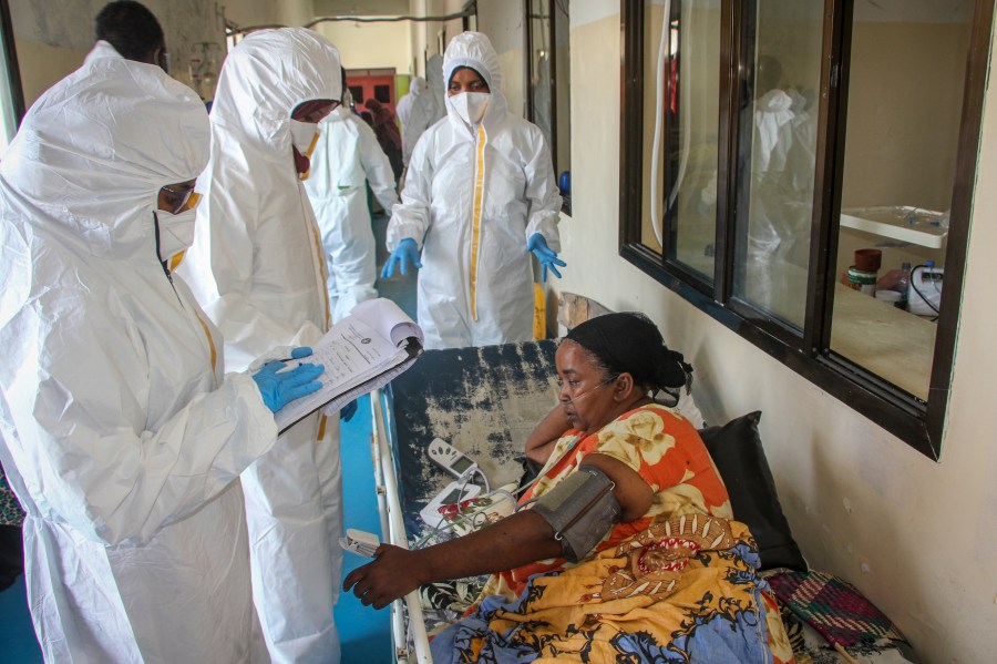 Doctors tend to a patient suffering from COVID-19 and receiving oxygen, in a ward for coronavirus patients at the Martini hospital in Mogadishu, Somalia on Feb. 24, 2021. (Farah Abdi Warsameh/Associated Press)