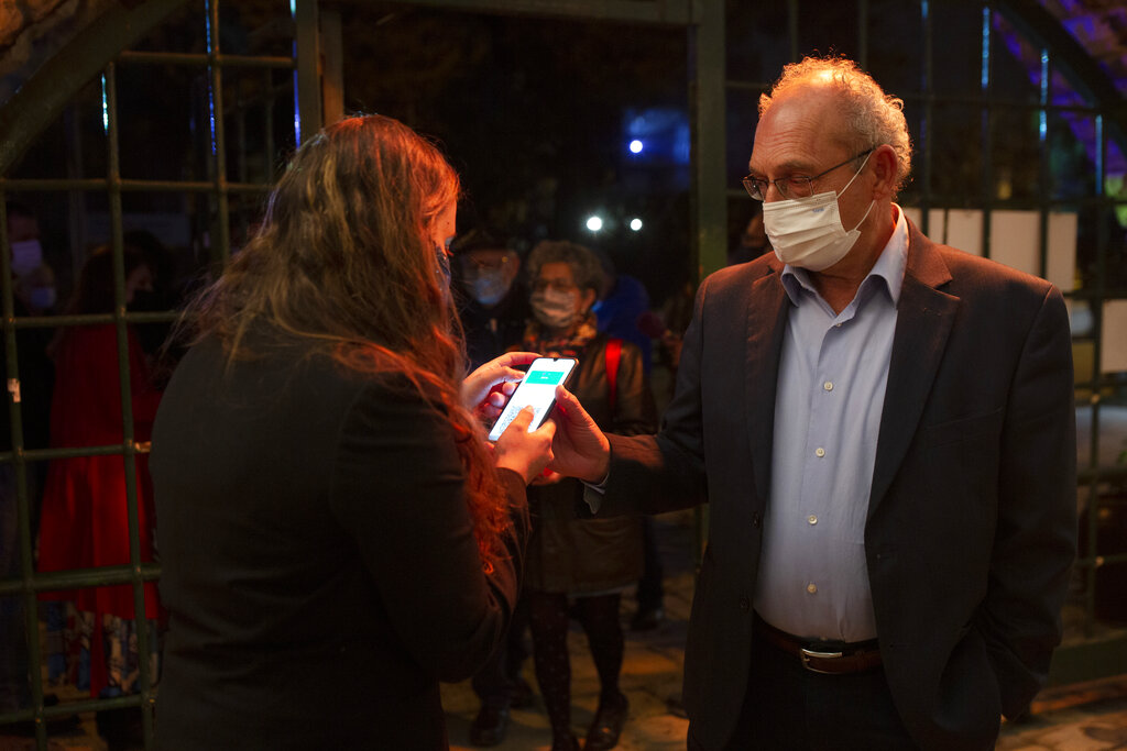 A man presents his "green passport," proof that he is vaccinated against COVID-19, at a theater in Jerusalem on Feb. 23, 2021. (AP Photo/Maya Alleruzzo)