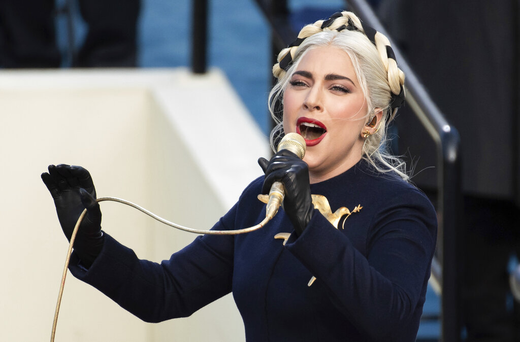 Lady Gaga sings the national anthem during President-elect Joe Biden's inauguration at the U.S. Capitol in Washington on Jan. 20, 2021. Officials say Lady Gaga’s dog walker was shot and her two French bulldogs stolen in Hollywood during an armed robbery. Los Angeles police are seeking two suspects, thought it’s not known if both were armed, in connection with the Wednesday night shooting. (Saul Loeb/Pool Photo via AP, File)