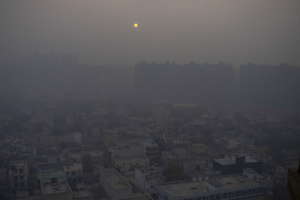 In this Saturday, Jan. 2, 2021 file photo, the morning sun is seen through a blanket of smog on the outskirts of New Delhi, India. (AP Photo/Altaf Qadri)