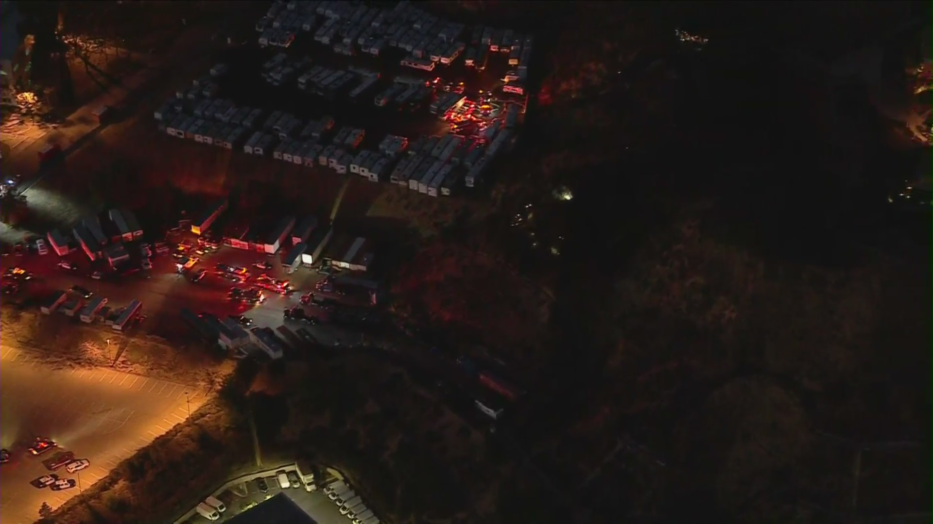 L.A. County Fire Department officials respond to a small brush fire sparked by an explosion at a movie set in Valencia on Feb. 2, 2021. (KTLA)