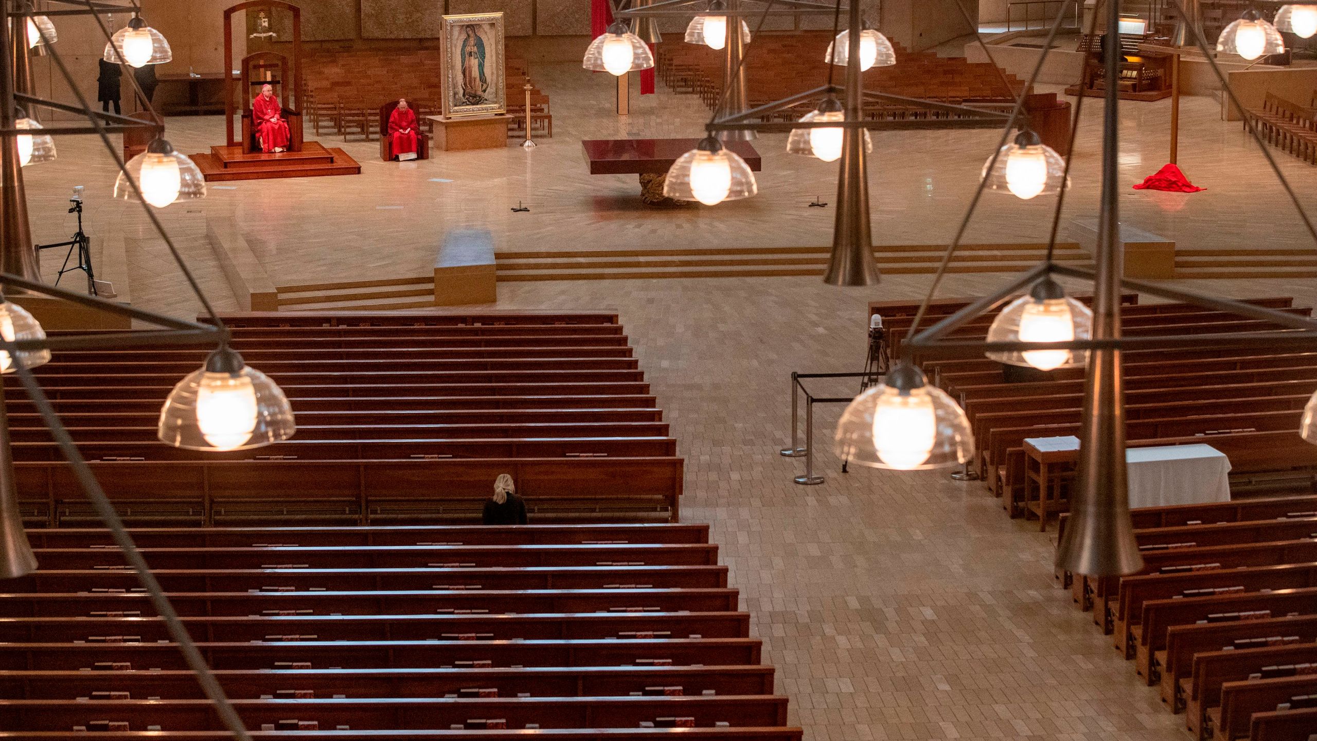 Archbishop Jose Gomez (L) and Father Brian Nunez celebrate Good Friday liturgy in an empty Cathedral of Our Lady of the Angels, April 10, 2020 in Los Angeles. (Brian van der Brug/AFP via Getty Images)