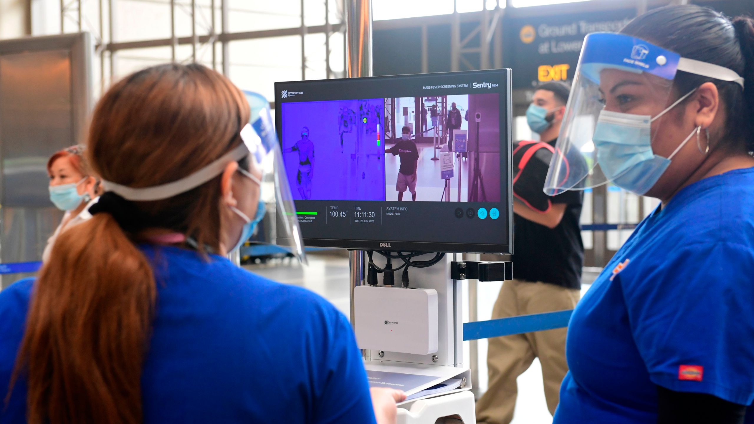 Passengers walks past thermal cameras, that check passenger's body temperatures, at Los Angeles International Airport on June 23, 2020. (FREDERIC J. BROWN/AFP via Getty Images)