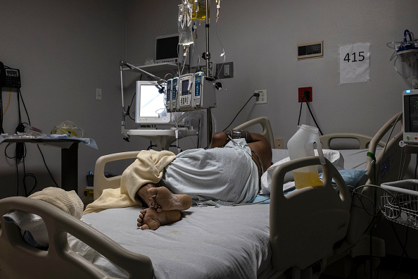 A patient is seen lying on a bed in the COVID-19 intensive care unit on New Year's Day 2021 at the United Memorial Medical Center in Houston, Texas. (Go Nakamura/Getty Images)