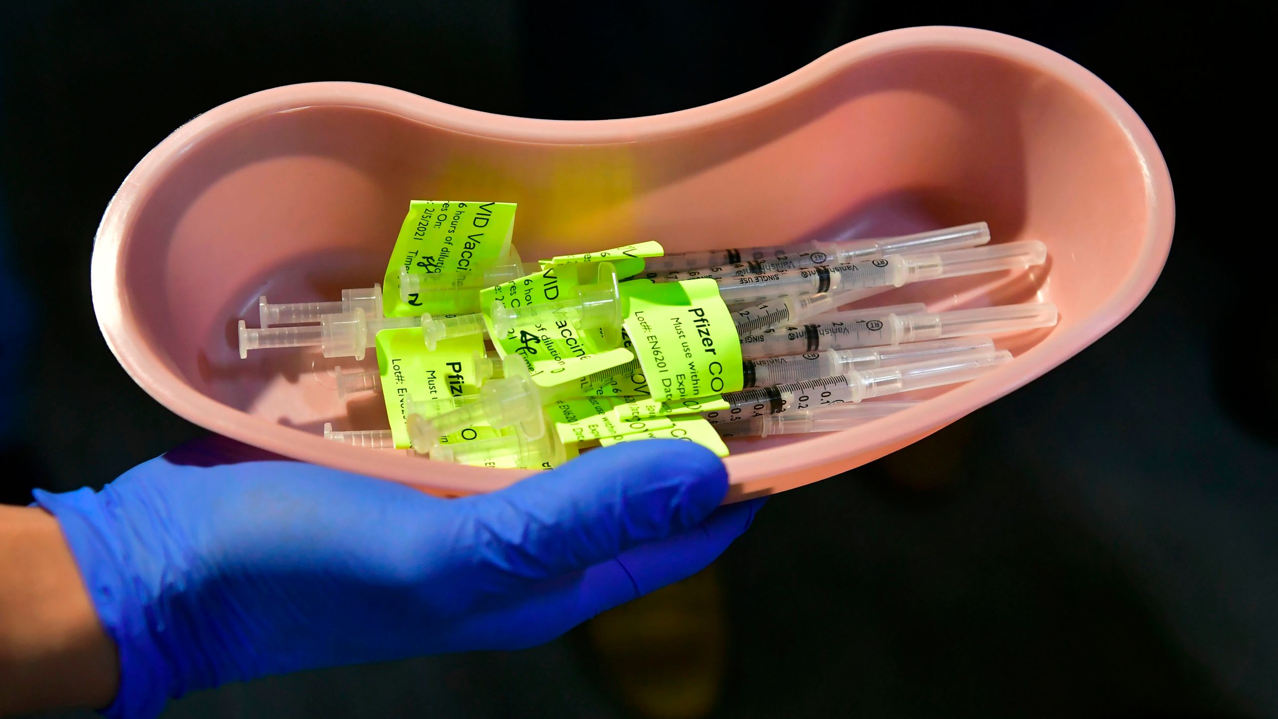 Syringes filled with the Pfizer COVID-19 vaccine are displayed on the opening day of a large-scale vaccination site at a parking structure in Pomona on Feb. 5, 2021. (FREDERIC J. BROWN/AFP via Getty Images)