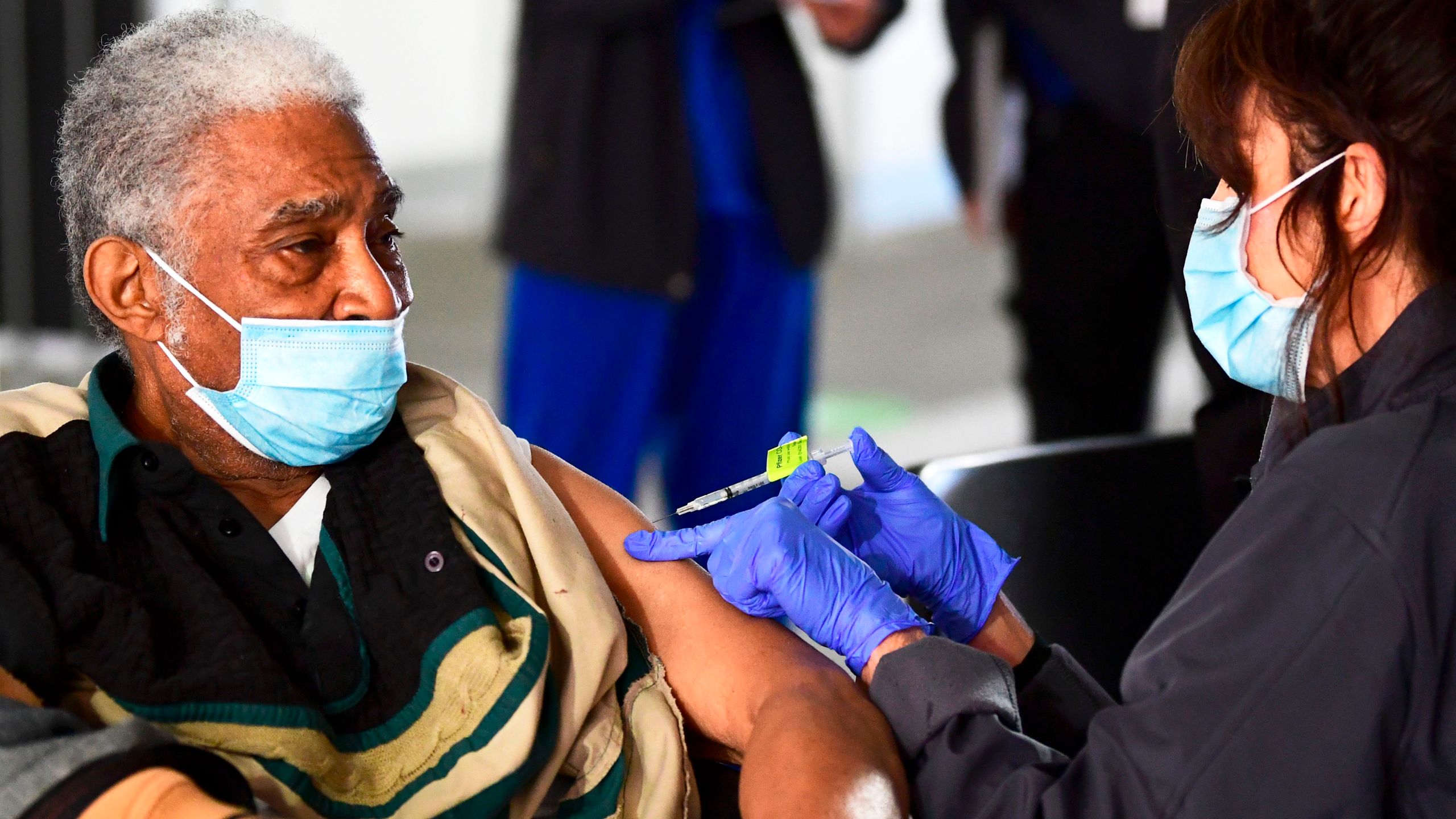 Elton Jackson, 80, looks on as he receives his COVID-19 vaccine at a parking structure at Cal Poly Pomona University in Pomona on Feb. 5, 2021. (FREDERIC J. BROWN/AFP via Getty Images)