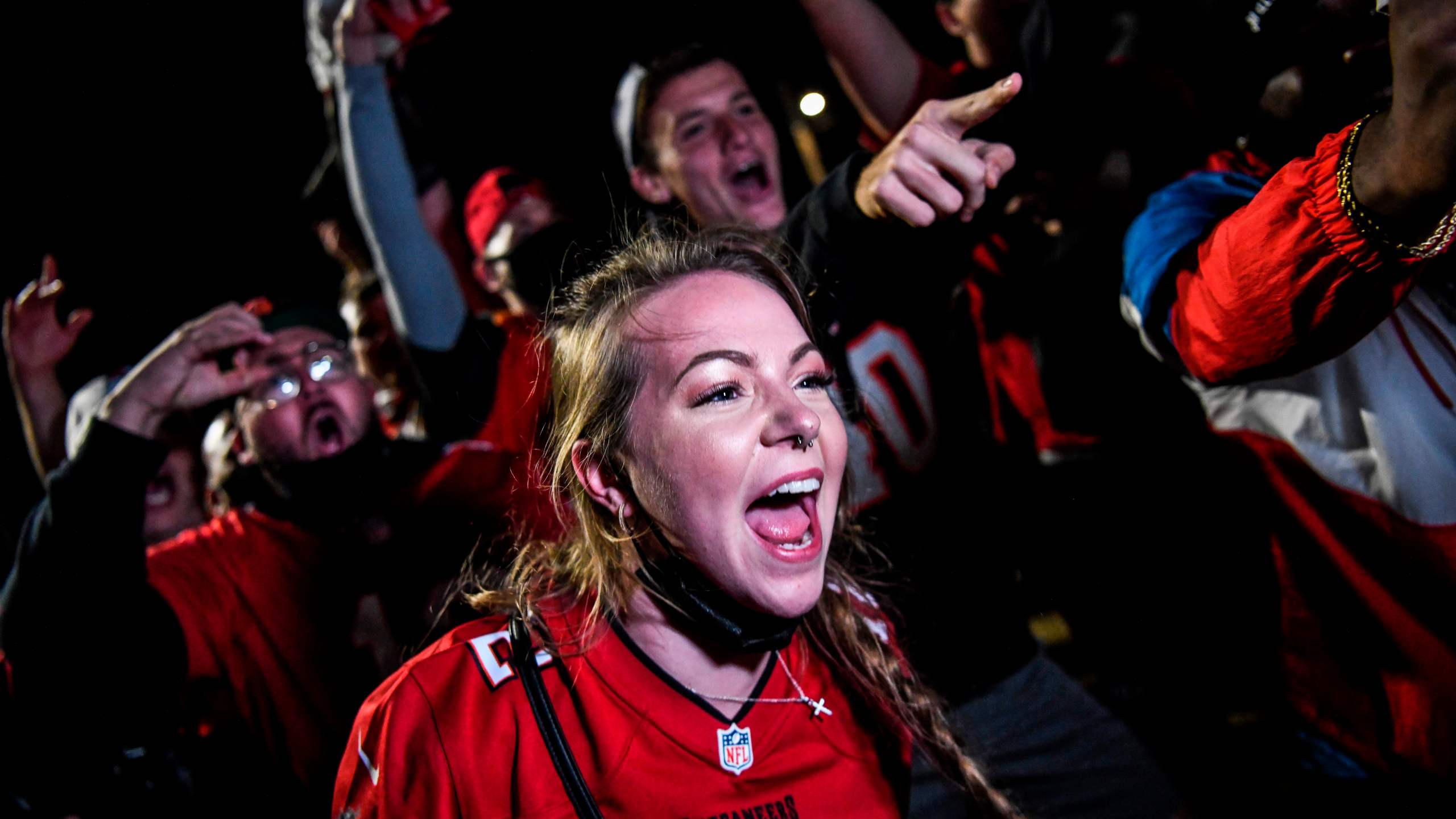 Tampa Bay Buccaneers fans celebrate their victory over the Kansas City Chiefs during Super Bowl LV in a parking lot near Raymond James Stadium in Tampa, Florida on Feb. 7, 2021. (CHANDAN KHANNA / AFP via Getty Images)