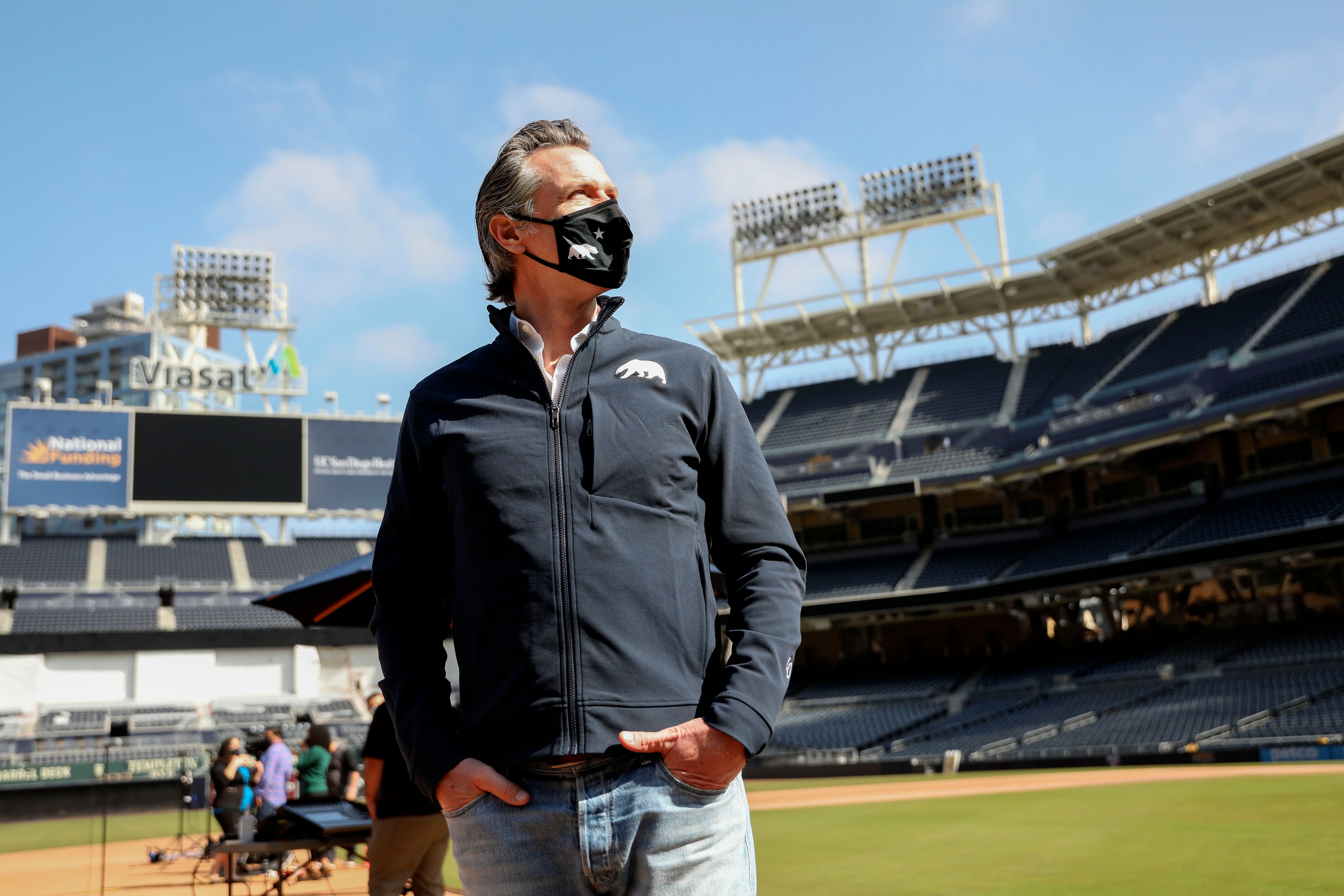 California Gov. Gavin Newsom looks on before speaking to members of the media during a press conference at Petco Park, February 8, 2021 in San Diego. (SANDY HUFFAKER/POOL/AFP via Getty Images)