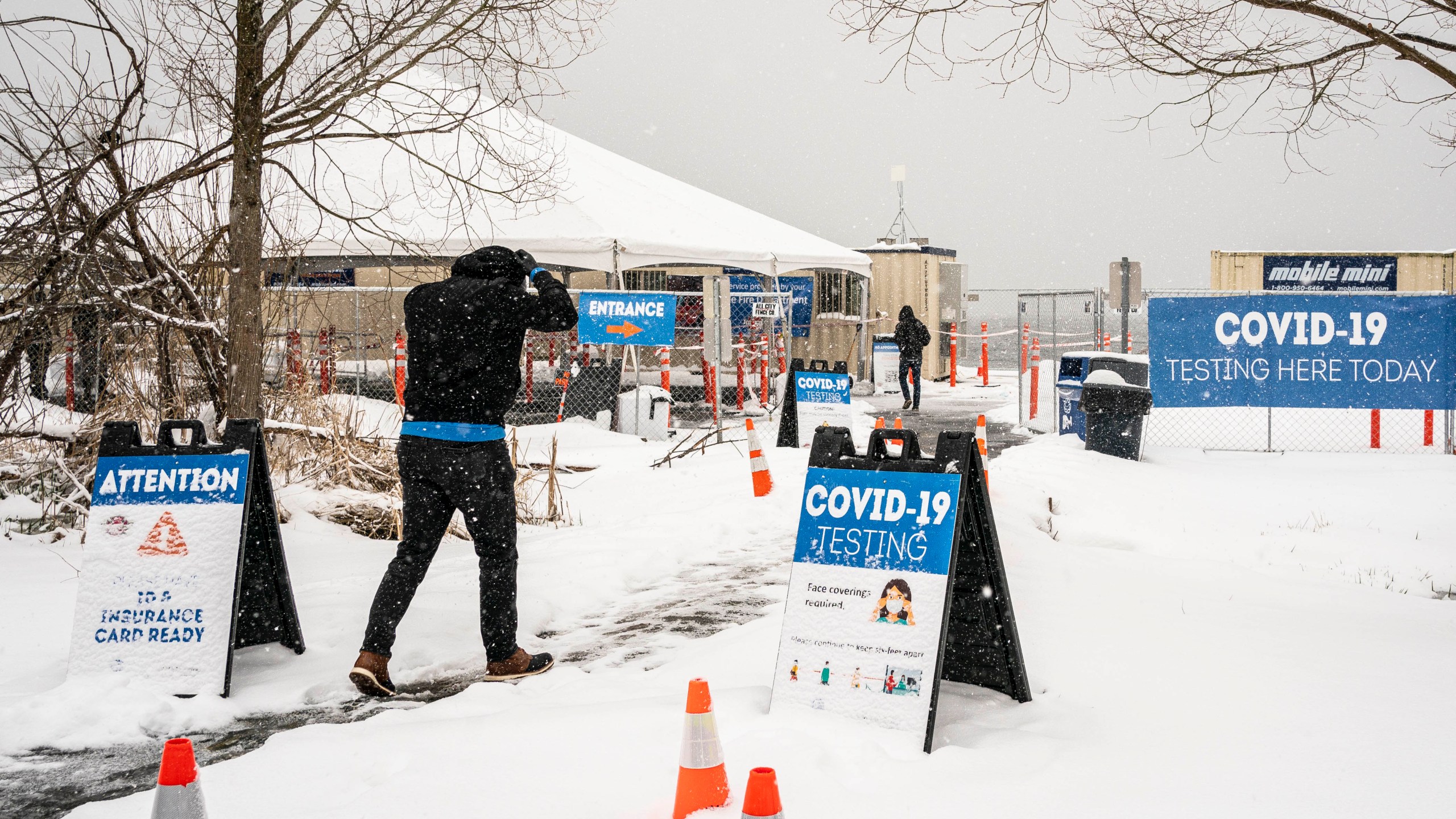 People enter a COVID-19 testing site on February 13, 2021 in Seattle, Washington. A large winter storm dropped heavy snow across the region. (David Ryder/Getty Images)