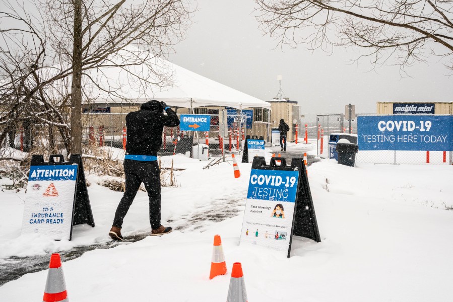 People enter a COVID-19 testing site on February 13, 2021 in Seattle, Washington. A large winter storm dropped heavy snow across the region. (David Ryder/Getty Images)