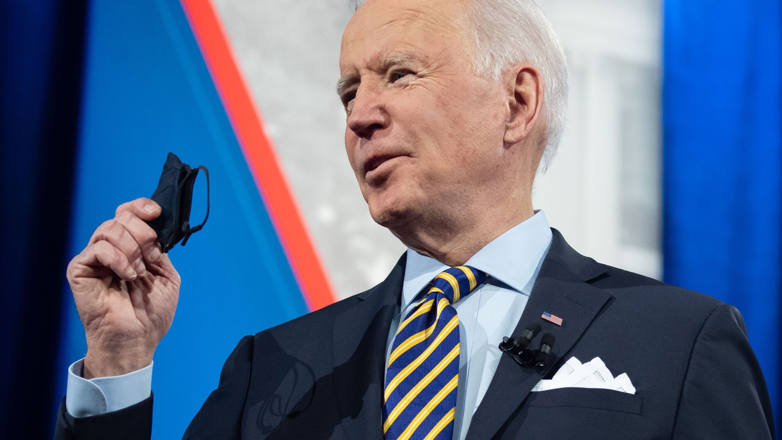 President Joe Biden holds a face mask as he participates in a CNN town hall at the Pabst Theater in Milwaukee, Wisconsin, on Feb. 16, 2021. (Saul Loeb / AFP / Getty Images)