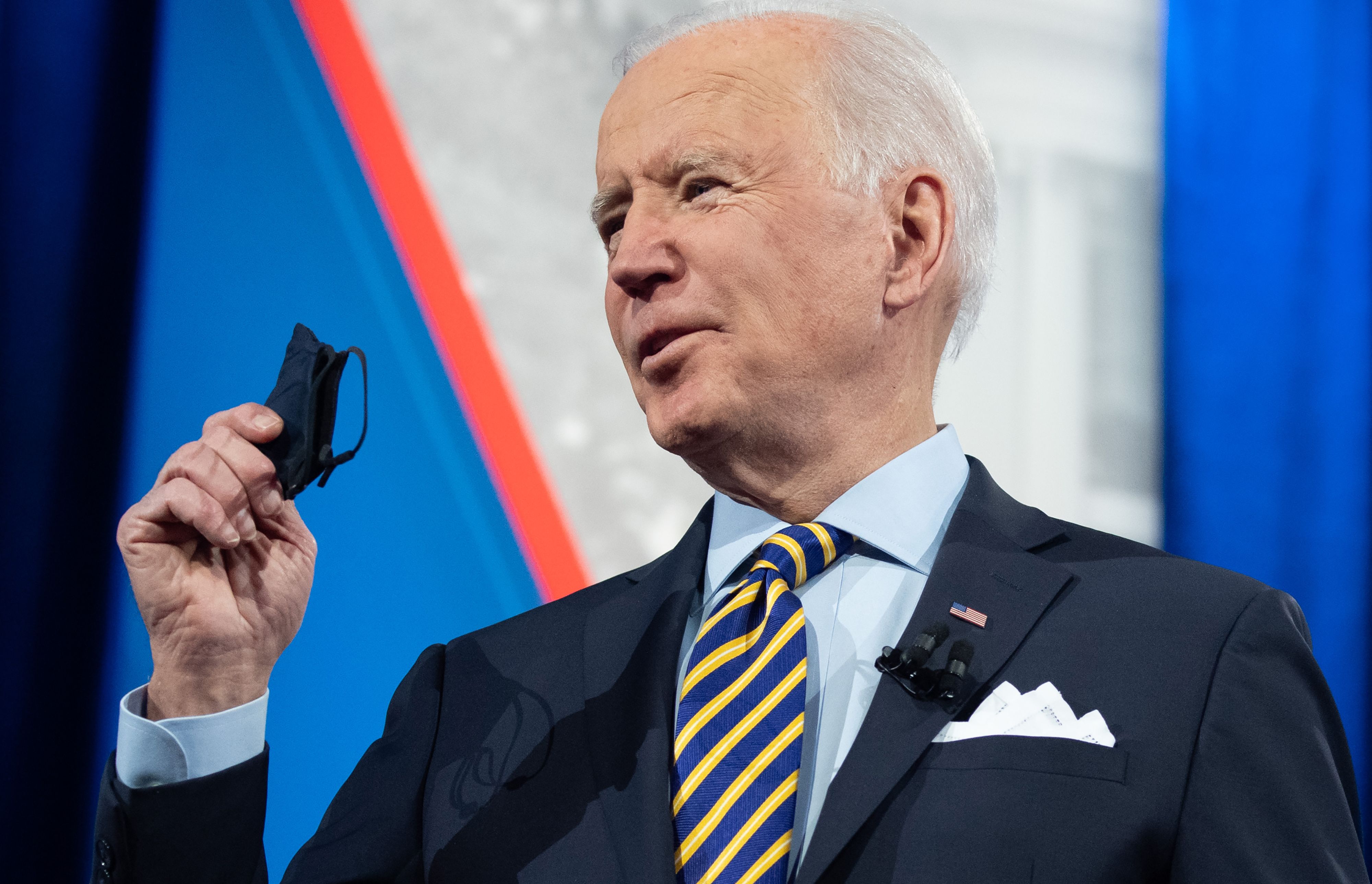 President Joe Biden holds a face mask as he participates in a CNN town hall at the Pabst Theater in Milwaukee, Wisconsin, on Feb. 16, 2021. (Saul Loeb / AFP / Getty Images)