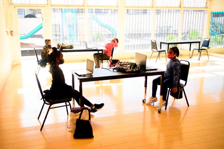 Children attend online classes at a learning hub inside the Crenshaw Family YMCA during the Covid-19 pandemic on February 17, 2021, in Los Angeles, California. (PATRICK T. FALLON/AFP via Getty Images)