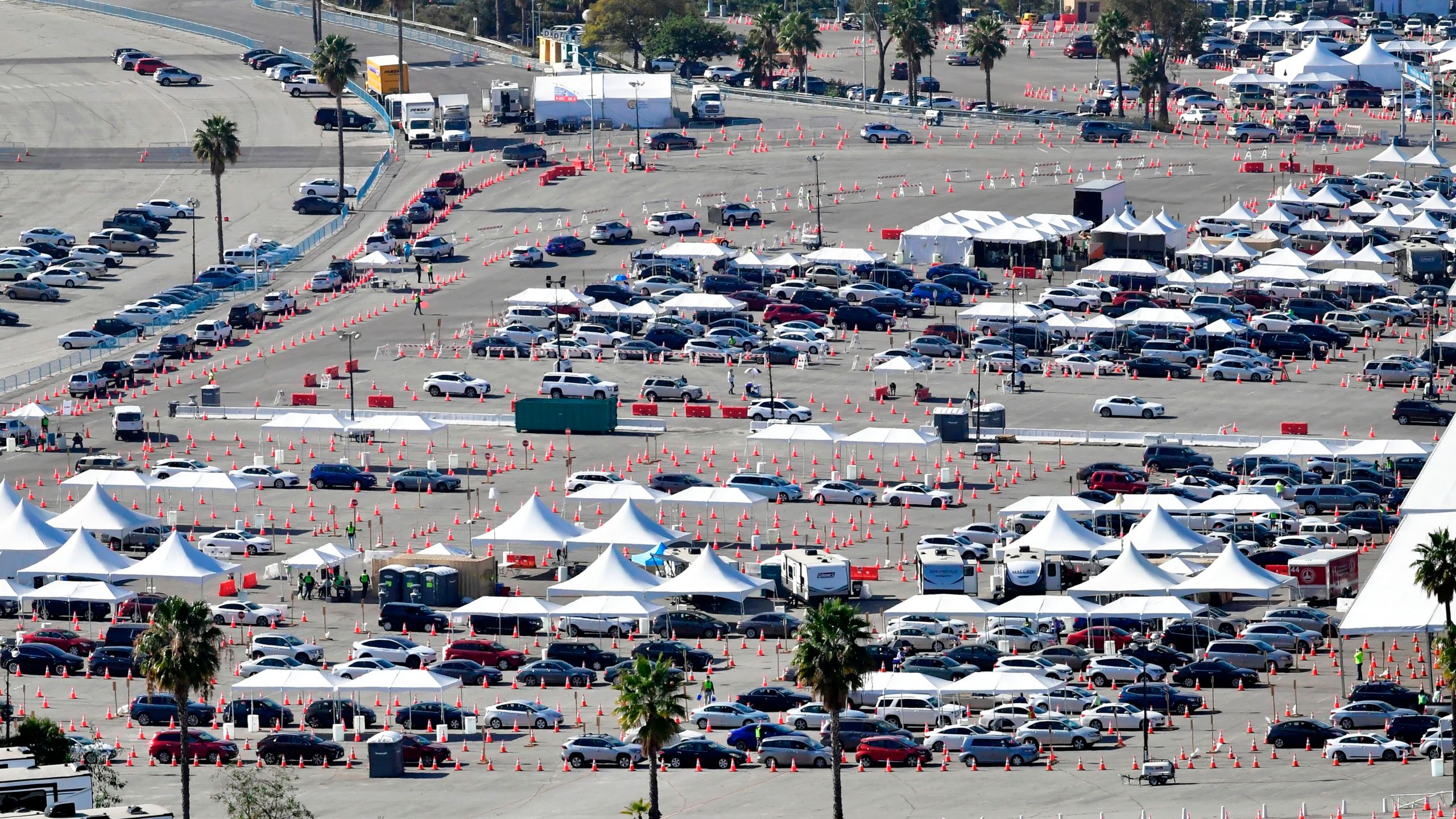 People in vehicles wait in line for their COVID-19 vaccinations in the parking lot at Dodger Stadium in Los Angeles, California on Feb. 25, 2021. (FREDERIC J. BROWN/AFP via Getty Images)