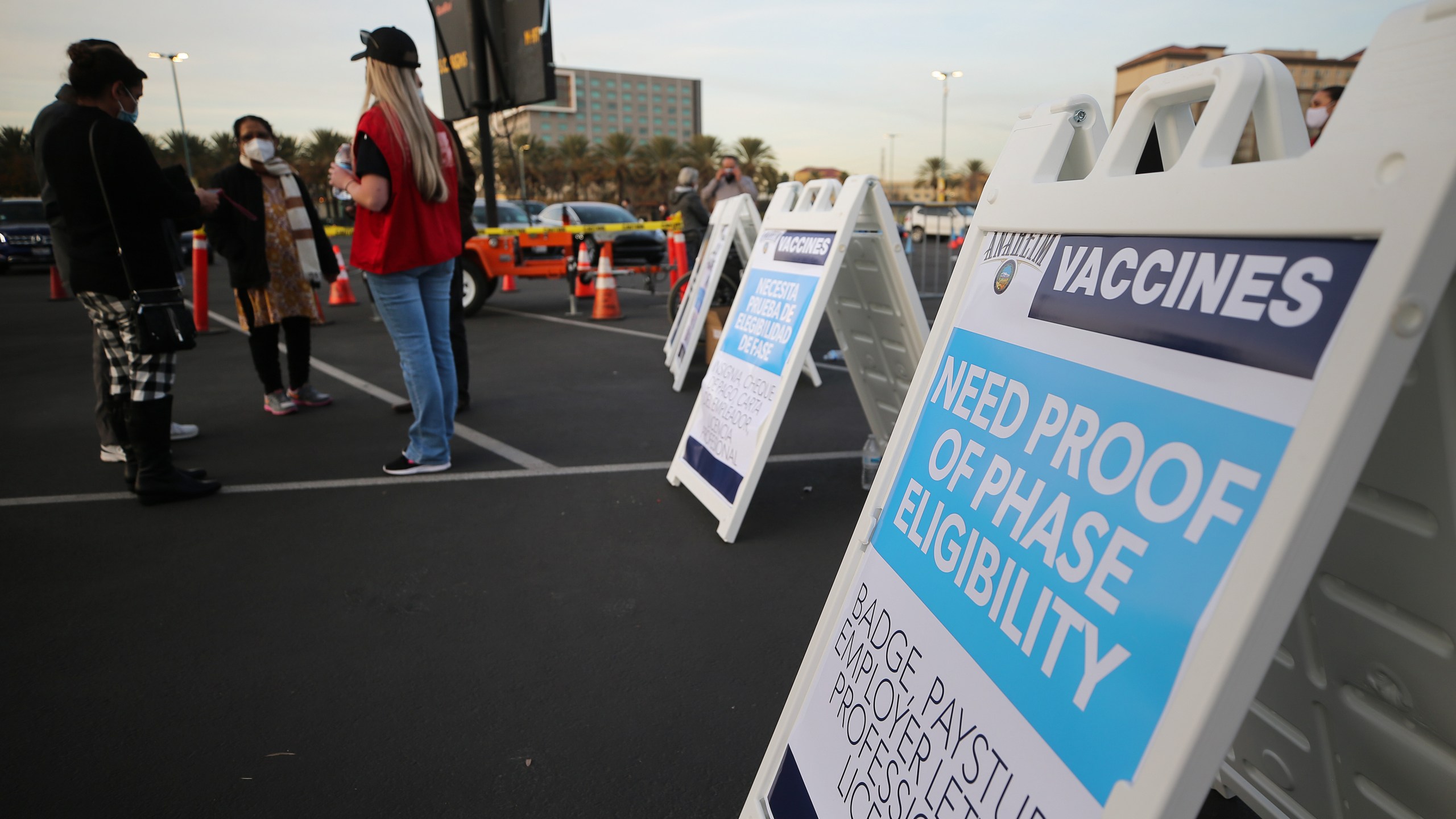 A sign is posted about proof of eligibility at a mass COVID-19 vaccination site in a parking lot of Disneyland Resort in Anaheim on Jan. 13, 2021. (Mario Tama / Getty Images)