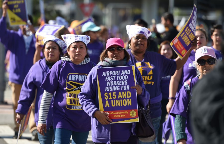 Union workers and supporters participate in a "Fight for $15" wage protest at Los Angeles International Airport in Los Angeles, on Nov. 29, 2016. Workers from fast-food chains, airports and other service industries rallied in U.S. cities as part of a nationwide day of disruption to demand union rights and a minimum wage of $15 an hour. Workers joining in included cabin cleaners, luggage handlers and other staff at O'Hare, Los Angeles and Fort Lauderdale airports. However, flights were not expected to be disrupted. (Robyn Beck /AFP via Getty Images)