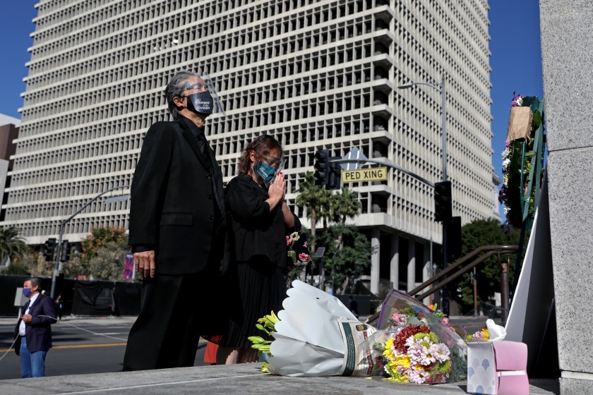 Court interpreter Nao Ikeuchi, left, and wife Yoshimi Shirata attend a vigil to honor two court interpreters at Los Angeles Superior Court who died recently of COVID-19.(Gary Coronado / Los Angeles Times)