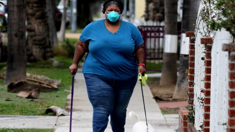 Ntombi Peters has severe asthma and takes immunosuppressant drugs to treat her multiple sclerosis. Changes in vaccine policy moved her farther back in line.(Luis Sinco / Los Angeles Times)