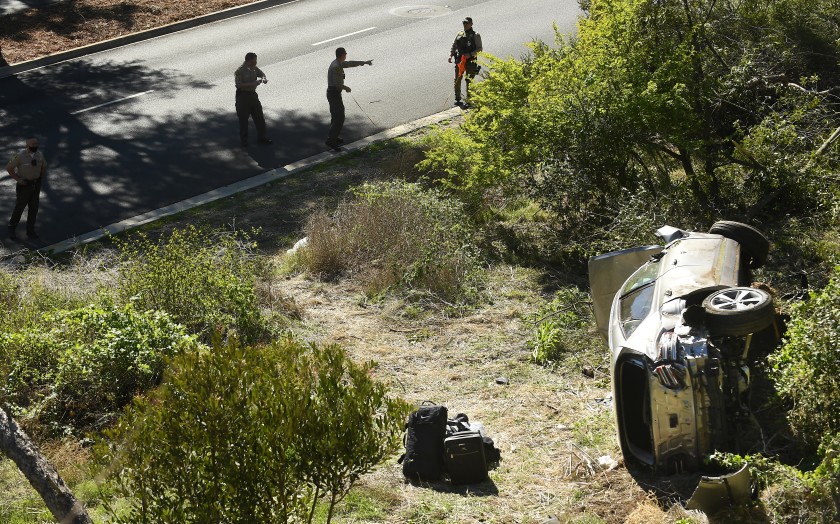 Los Angeles County sheriff’s deputies investigate a crash involving Tiger Woods along Hawthorne Boulevard in Rancho Palos Verdes on Feb. 23, 2021. (Wally Skalij / Los Angeles Times)