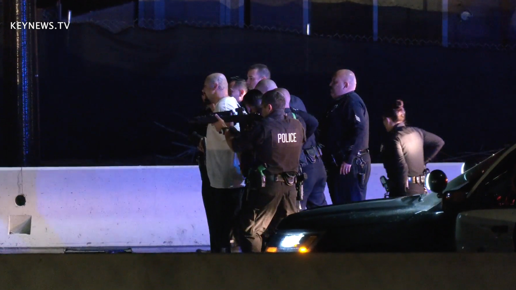 A driver is handcuffed following a lengthy pursuit that wound its way through Los Angeles County and ended on the 10 Freeway in Ontario in the early morning hours of Feb. 3, 2021. (KeyNews.TV)