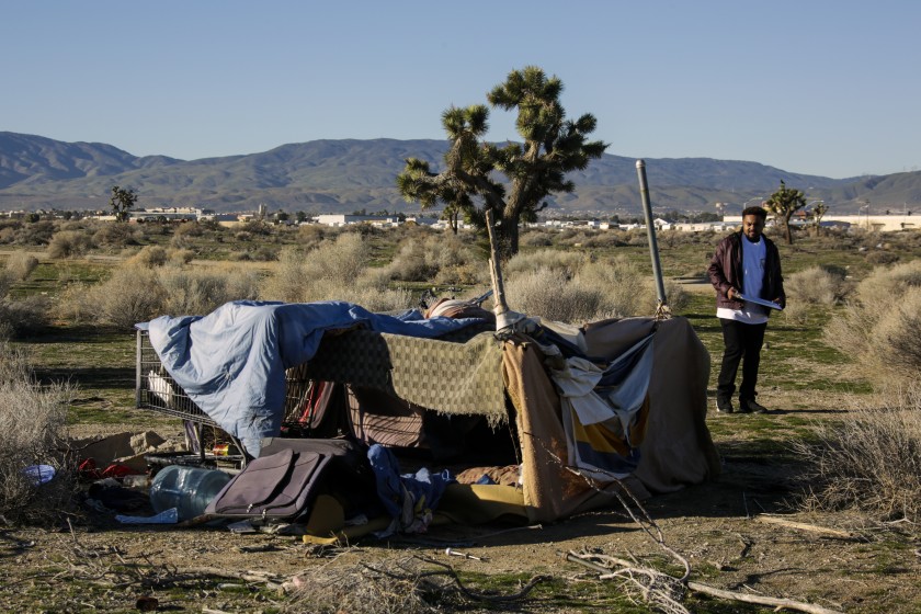 Derrick Chambers performs a count of homeless people at a Lancaster encampment during the 2016 homeless census. (Irfan Khan / Los Angeles Times)